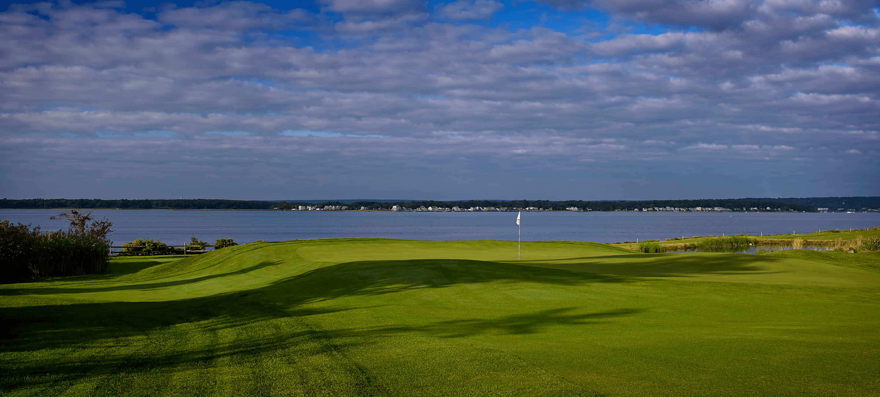 image of golf green along waterway
