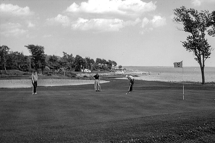 Three golfers at the 9th hole in 1960s